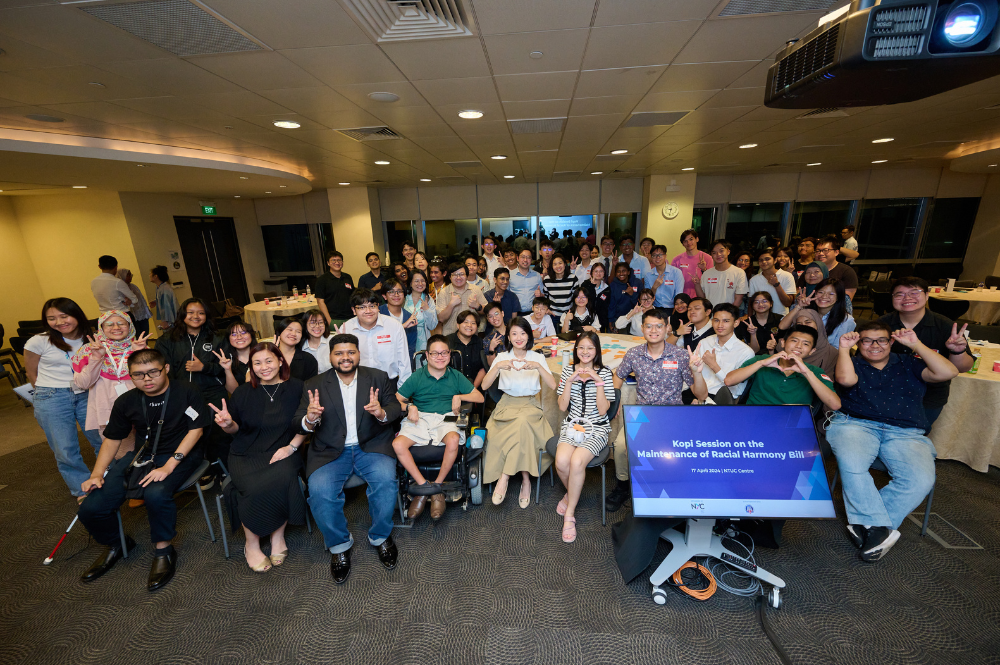 Large group posing, some with peace signs and hearts